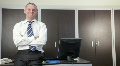 Portrait of happy businessman at work and smiling in office