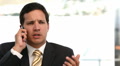Angry businessman talking on the phone