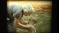Cute blonde baby boy and elderly Grandmother hug and kiss