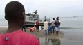 Boy watching a US Navy boat land on beach. m