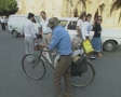 Man pushes bike along the street Video