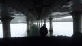 Person Walking Under the Bridge