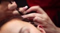 Process of braiding by hands, no faces are visible