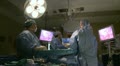 Surgeons watch monitor while performing laparoscopic surgery (12of 18)