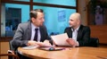 Two businessmen working with documents in the office, steadicam shot HD