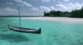 Tropical Paradise at Maldives - Sail boat with island shore in distance