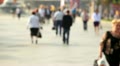 People go down the street. Defocused Video