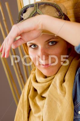 Stock photo of young woman sunburned face with pilot goggles