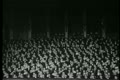 Wide shot of audience in theater