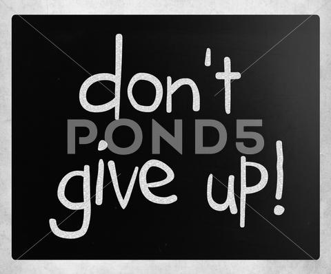 Stock Illustration of "don't give up" handwritten with white chalk on a blackboard