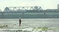 Silhouette of the fisherman standing in the river Video