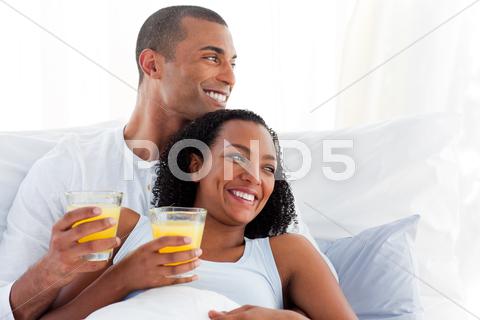 Stock photo of Romantic couple drinking orange juice