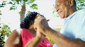 Retired Ethnic Seniors Dancing Outdoors