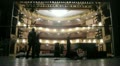 Working scenes dismantle scenery after performance in theatre.
