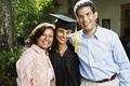 Graduate and parents smiling for the camera