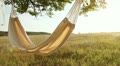 Hammock swinging on the wind at sunset