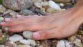 Hand touching stones