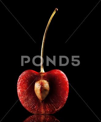 Stock photo of halved red cherry