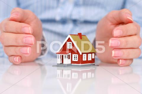 Stock photo of hands and house.