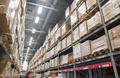 rows of shelves with boxes in modern warehouse
