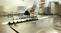 Cleaner cleaning a counter in a kitchen