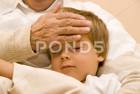 Stock photo of Grandpa touch the head of his grandson