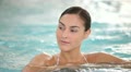 young woman in spa relaxing in jacuzzi water