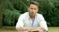 man sitting in garden talking to camera