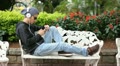 Boy listening music on mobile phone with earphone