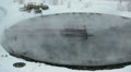 Round settler with overflowing water and vapour in winter season Video