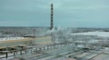 Freight train passing far a distance of water treatment factory with big chimney Video