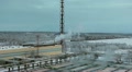 Freight train passing far a distance of water treatment plant Video