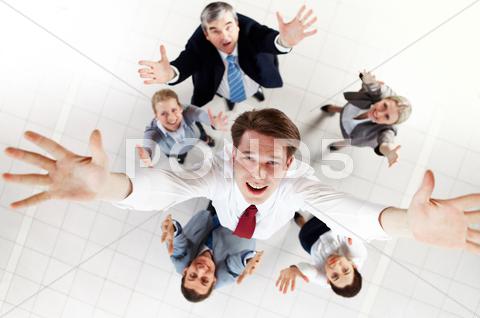 Stock photo of above view of happy chief being thrown by several partners upwards