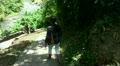Girl going steps downward to a tropic waterfall - Bali part 1/2 Video