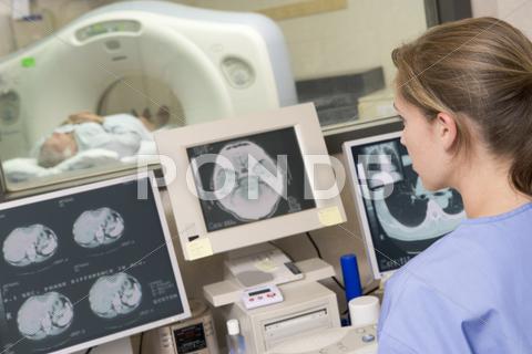 Nurse Monitoring Patient Having A Computerized Axial Tomography (Cat) Scan