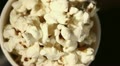 white glass with popcorn rotates close up. Top view Video