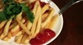 French fries on a plate with ketchup and a fork Video