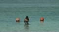 Beautiful girl walking in the ocean while low tide Video