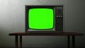 old TV with a green screen in the room