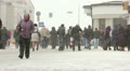 Crowd of people in a blizzard in the winter in the city. Editorial Video