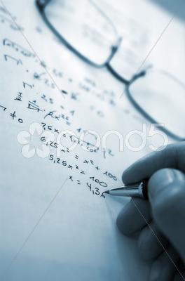 Stock photo of young man doing the maths homework