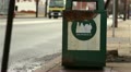 Rusty Public Garbage Can with Sign