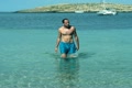 Young man comes out of the sea after swimming, slow motion shot at 240fps