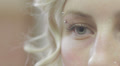 A young woman opens and closes her blue eye - macro Video