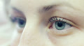 Young woman opens and closes her eyes - macro Video