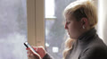 Beautiful young woman sends sms Video