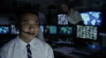 Security personnel working in system control room.