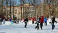 People are skating on the open skating ring in winter