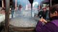 Japanese people burning aromatic sticks in the incense burner Video