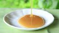 Honey for breakfast. Pouring fresh honey on a small breakfast plate. Video